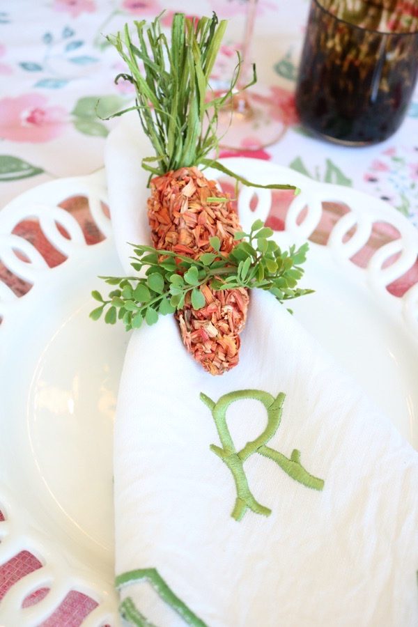 Green linen napkins and napkin rings add balance to pink Easter table